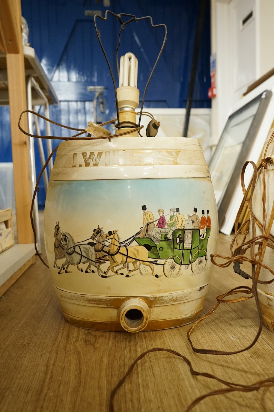 A pair of pottery Irish Whiskey and Rum spirit barrels, coaching scenes, converted to lamps, 56cm high overall